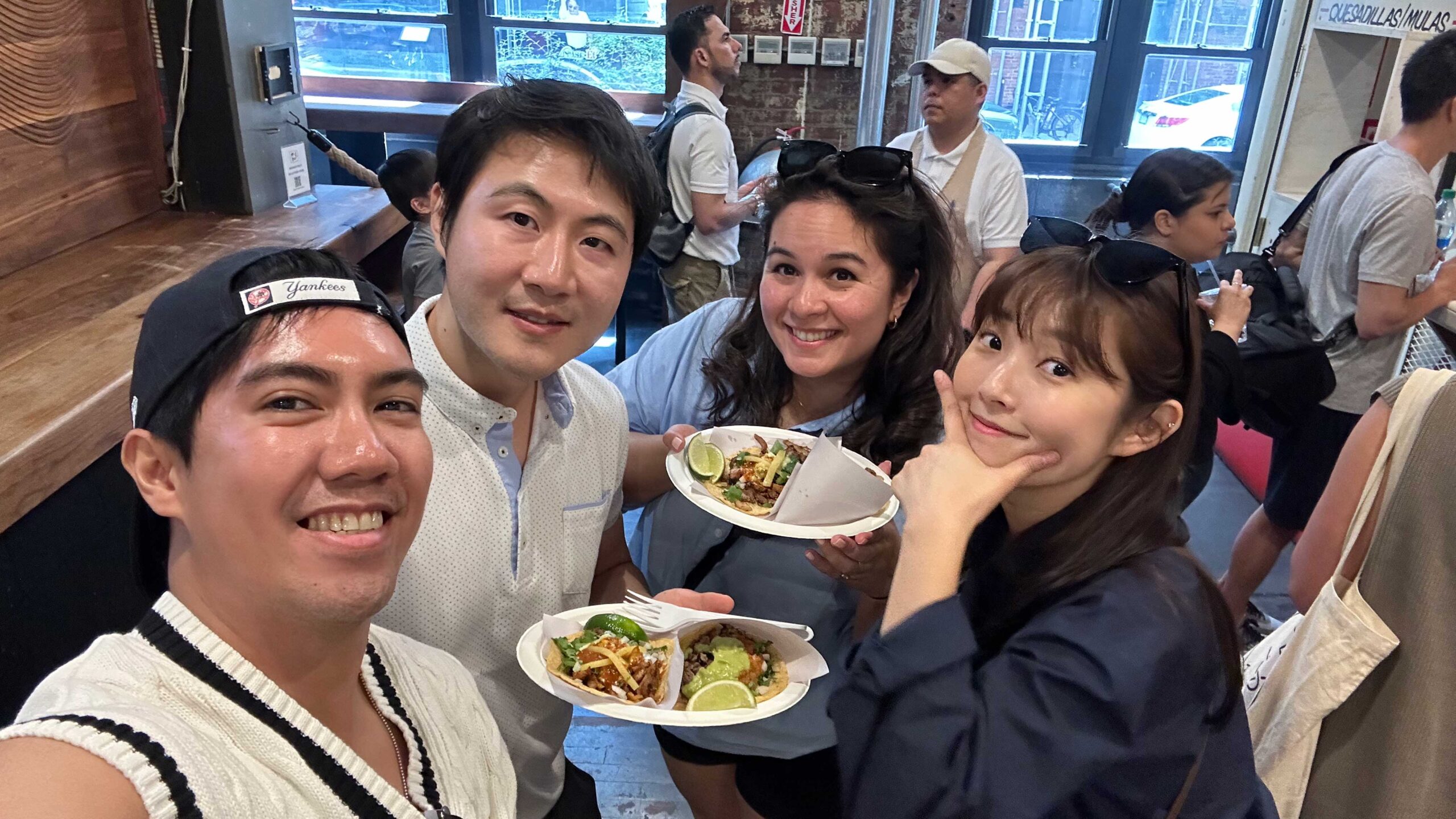 4 friends eating tacos in chelsea market